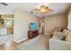 A cozy living room featuring hardwood floors, a ceiling fan, comfortable furniture, and a TV at 12400 Park Blvd # 519, Seminole, FL 33772