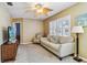 Comfortable living room featuring hardwood floors, a ceiling fan, plantation shutters, and a TV at 12400 Park Blvd # 519, Seminole, FL 33772