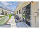 View of the property's walkway with covered patio, sliding glass doors, and well-maintained landscaping at 12400 Park Blvd # 519, Seminole, FL 33772