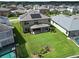 A beautiful backyard featuring a green lawn with a patio and solar panels on the roof at 12821 Satin Lily Dr, Riverview, FL 33579