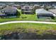 Aerial view featuring a large backyard with a manicured lawn, patio, and neighborhood swimming pools at 12821 Satin Lily Dr, Riverview, FL 33579