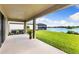 Tranquil backyard featuring a large covered patio and lush lawn with a lake view at 12821 Satin Lily Dr, Riverview, FL 33579