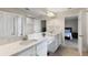 Bright bathroom features double sinks, modern fixtures, and a decorative tile backsplash in the walk-in shower at 12821 Satin Lily Dr, Riverview, FL 33579
