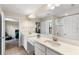 Bright bathroom featuring dual sinks with modern fixtures, framed mirror, and separate shower area at 12821 Satin Lily Dr, Riverview, FL 33579