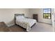 Cozy bedroom with neutral carpet, window view, and matching wood furniture at 12821 Satin Lily Dr, Riverview, FL 33579