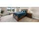 Comfortable bedroom featuring a wooden bed frame, soft bedding, and sun-drenched windows at 12821 Satin Lily Dr, Riverview, FL 33579