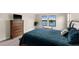 Bedroom featuring a plush bed with a wooden dresser and bright windows overlooking the exterior at 12821 Satin Lily Dr, Riverview, FL 33579