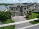 Aerial shot of a well-maintained two-story home with solar panels and a manicured lawn at 12821 Satin Lily Dr, Riverview, FL 33579