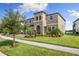 Inviting two-story home with a manicured lawn and a three-car garage at 12821 Satin Lily Dr, Riverview, FL 33579