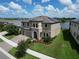 Beautifully landscaped two-story home with solar panels and a tranquil lake view at 12821 Satin Lily Dr, Riverview, FL 33579