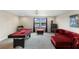 Bright game room with a pool table, plush seating, and picturesque outdoor views at 12821 Satin Lily Dr, Riverview, FL 33579
