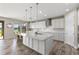 Bright kitchen with white cabinets, central island, and lake views at 12821 Satin Lily Dr, Riverview, FL 33579