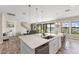 Bright kitchen featuring a large island, stainless steel appliances, and sliding doors to the backyard at 12821 Satin Lily Dr, Riverview, FL 33579
