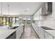 Modern kitchen featuring white cabinets, a large island, and waterfront views at 12821 Satin Lily Dr, Riverview, FL 33579