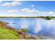 Picturesque lake view showcasing beautiful sky reflection on a partly cloudy day at 12821 Satin Lily Dr, Riverview, FL 33579
