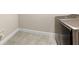 Clean laundry room with gray tile flooring and modern washer and dryer at 12821 Satin Lily Dr, Riverview, FL 33579