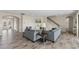 Open living area featuring two couches and an entryway to the front door at 12821 Satin Lily Dr, Riverview, FL 33579