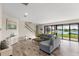 Spacious living room features a cozy seating area, staircase, and sliding glass doors with a view at 12821 Satin Lily Dr, Riverview, FL 33579