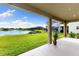 Covered patio with a view of the lake and backyard, offering a serene outdoor space at 12821 Satin Lily Dr, Riverview, FL 33579