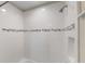 Bright white tiled shower features a shower head, wall niche, and decorative accent tiles at 12821 Satin Lily Dr, Riverview, FL 33579