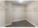 A spacious walk-in closet with wire shelving and carpeted floors, offering ample storage at 12821 Satin Lily Dr, Riverview, FL 33579