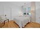 Serene bedroom features a plush bed, hardwood floors, and soft natural light, providing a relaxing retreat at 1415 7Th N Ave, St Petersburg, FL 33705
