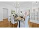 Bright dining room features hardwood floors, white walls, and a modern chandelier, creating an elegant and inviting space at 1415 7Th N Ave, St Petersburg, FL 33705