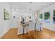 Bright dining room features hardwood floors, white walls, and a modern chandelier, creating an elegant and inviting space at 1415 7Th N Ave, St Petersburg, FL 33705