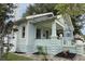 This charming home features light blue siding, stone accents and inviting front porch at 1415 7Th N Ave, St Petersburg, FL 33705