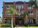 Brick hotel building featuring an American flag, colorful decorations, and palm trees at 1415 7Th N Ave, St Petersburg, FL 33705