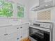 Bright kitchen with white cabinets, stainless steel appliances, and hardwood floors at 1415 7Th N Ave, St Petersburg, FL 33705