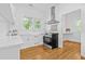 Bright kitchen with white cabinets, stainless steel appliances, and hardwood floors at 1415 7Th N Ave, St Petersburg, FL 33705