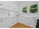 Bright kitchen with white cabinets, stainless steel appliances, and hardwood floors at 1415 7Th N Ave, St Petersburg, FL 33705