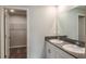 Stylish bathroom featuring dual sinks, a large mirror, and a doorway, combining functionality with a touch of elegance at 14817 Summer Branch Dr, Lithia, FL 33547