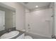 Bright bathroom features a tub with shower, a white sink, and a large mirror, providing a refreshing space at 14817 Summer Branch Dr, Lithia, FL 33547