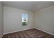 Bright bedroom featuring neutral walls, plush carpet, and a window offering natural light and neighborhood views at 14817 Summer Branch Dr, Lithia, FL 33547