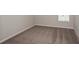 Neutral carpeted bedroom with base trim and a window at 14817 Summer Branch Dr, Lithia, FL 33547