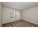 Bedroom features neutral walls, plush carpeting and two windows with blinds, offering a comfortable retreat at 14817 Summer Branch Dr, Lithia, FL 33547