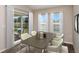 Cozy dining room featuring a wood table with seating for six and sliding door access to the backyard patio at 14817 Summer Branch Dr, Lithia, FL 33547