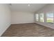 Bright, empty room with three windows, offering plenty of natural light and versatile space at 14817 Summer Branch Dr, Lithia, FL 33547