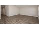 Spacious room with wood-look flooring and natural light, offering a blank canvas for customization at 14817 Summer Branch Dr, Lithia, FL 33547