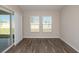 Light-filled room with sliding glass doors and two windows, offering a versatile space for various uses at 14817 Summer Branch Dr, Lithia, FL 33547