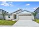 Charming single-story home featuring a two-car garage and well-maintained landscaping at 14817 Summer Branch Dr, Lithia, FL 33547
