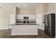 Bright kitchen with stainless steel appliances, white cabinets, and a convenient island at 14817 Summer Branch Dr, Lithia, FL 33547