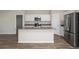 Modern kitchen featuring white cabinets, stainless steel appliances, and a center island at 14817 Summer Branch Dr, Lithia, FL 33547