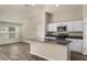 Modern kitchen with stainless appliances and white cabinets, and with an eat-in kitchen island at 14817 Summer Branch Dr, Lithia, FL 33547