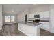 Bright kitchen with stainless steel appliances, an island, and adjacent living area at 14817 Summer Branch Dr, Lithia, FL 33547