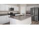 Well-lit kitchen features stainless appliances, ample counter space, and streamlined design at 14817 Summer Branch Dr, Lithia, FL 33547