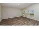 Bright living room features modern floors, three windows, and neutral walls, offering a versatile living space at 14817 Summer Branch Dr, Lithia, FL 33547