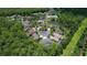 Expansive aerial view showcasing a tranquil neighborhood with lush greenery and a serene pond at 16102 Colchester Palms Dr, Tampa, FL 33647